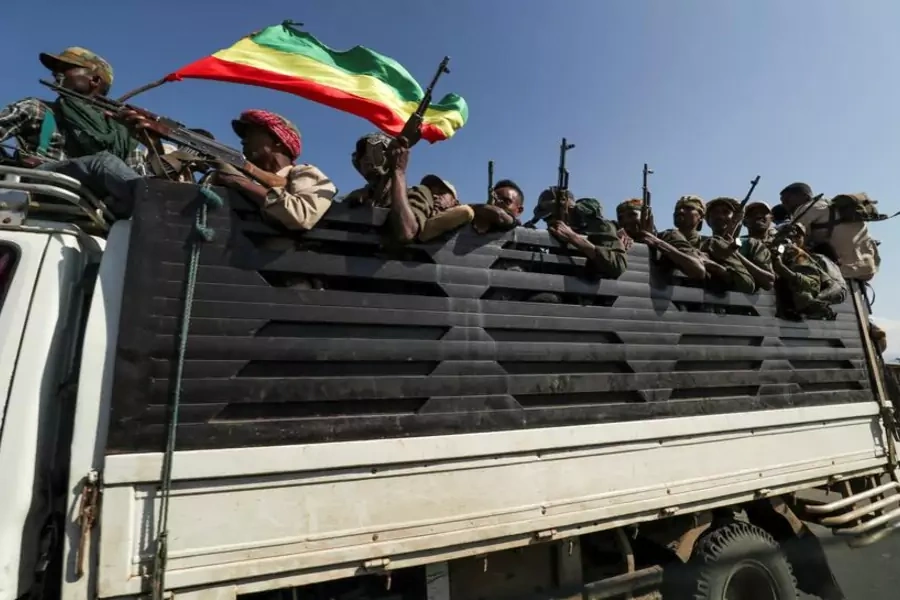 Amhara militia members ride in the back of a truck towards a fight with the Tigray People's Liberation Front.