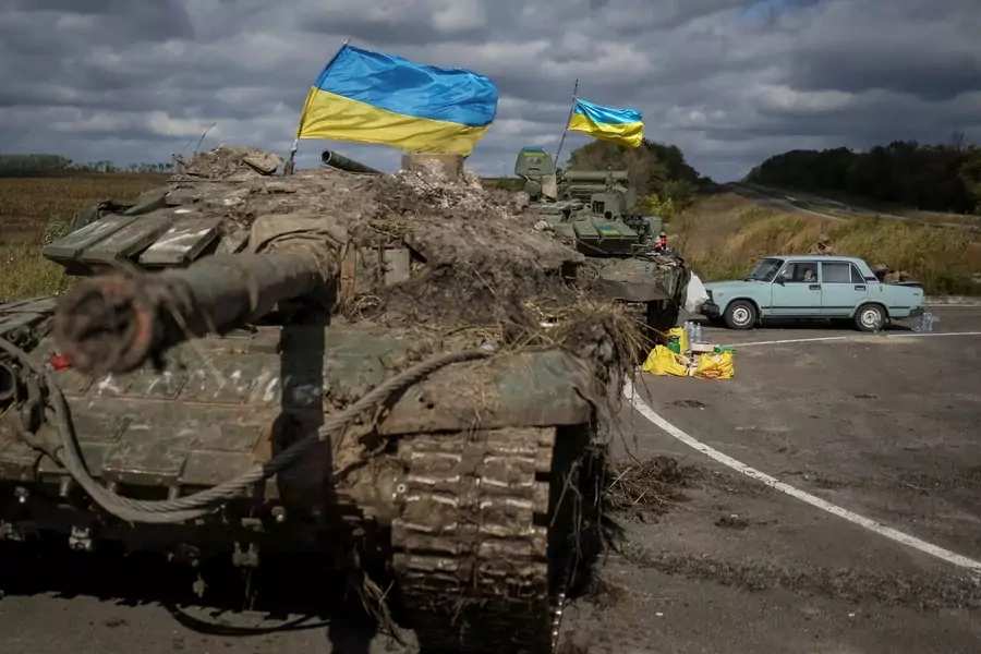 Ukranian flags fly above captured Russian tanks on September 19, 2022, near the town of Izium.