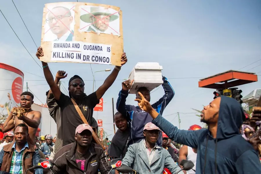 A civilian carries a sign at a protest in support for the Armed Forces of the Democratic Republic of the Congo (FARDC) soldiers, following renewed tensions around Goma in the Democratic Republic of Congo on October 31, 2022.