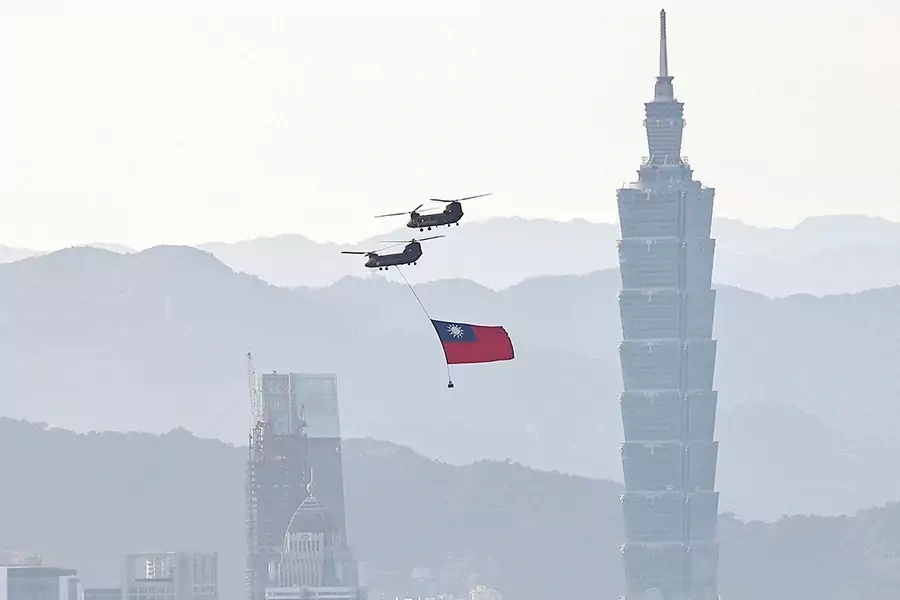 A CH-47 flies across Taipei during a rehearsal ahead of National Day celebrations