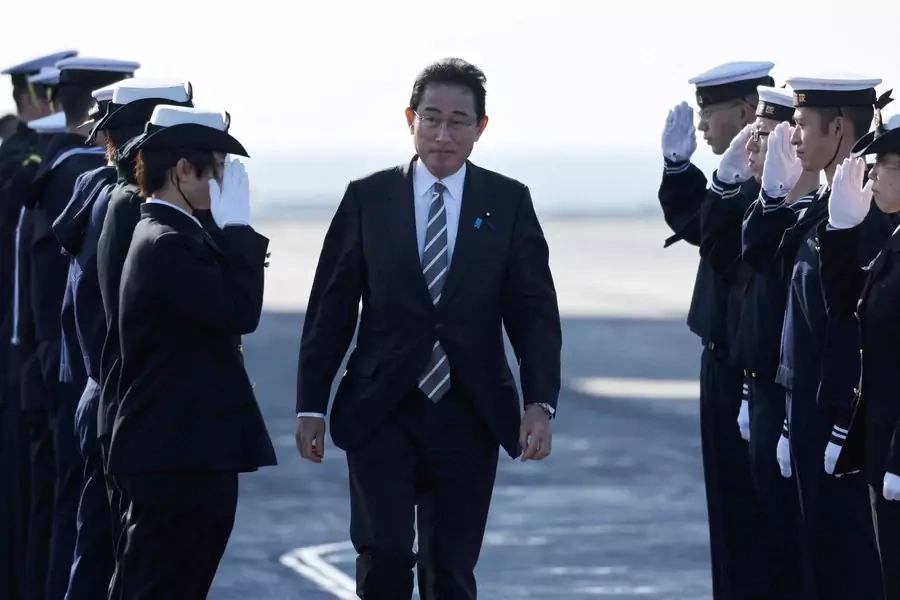 Japan's Prime Minister Fumio Kishida receives salutes from Japan Maritime Self-Defence Force (JMSDF) soldiers during the International Fleet Review to commemorate the 70th anniversary of the foundation of the JMSDF, at Sagami Bay.