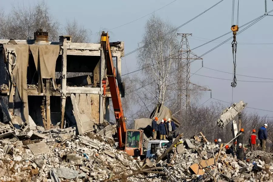 Workers remove debris in the aftermath of a Ukrainian strike on January 1st on a vocational school housing Russian soldiers, which reportedly killed hundreds of Russian soldiers.