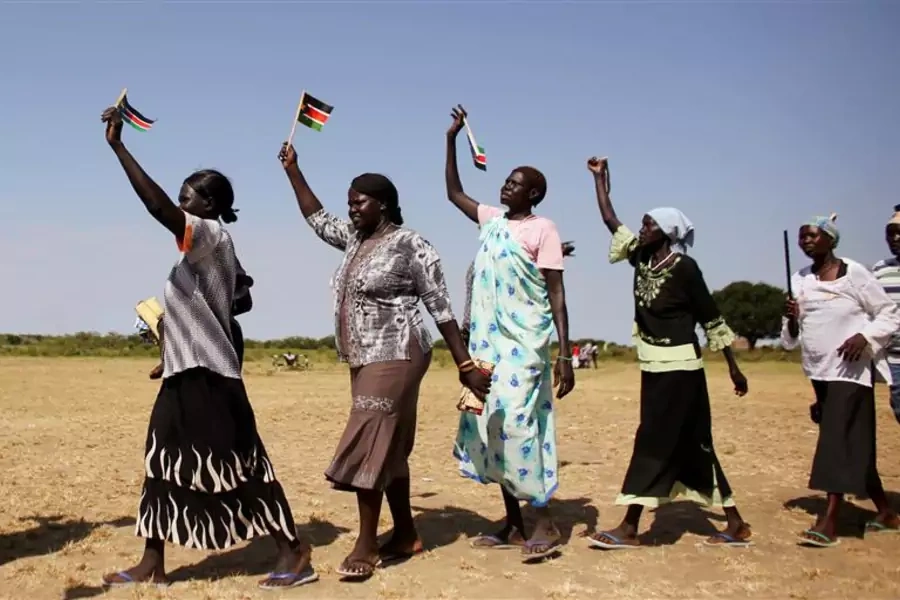 Women wave South Sudan's flags during a rally in the town of Abyei ahead of the referendum.