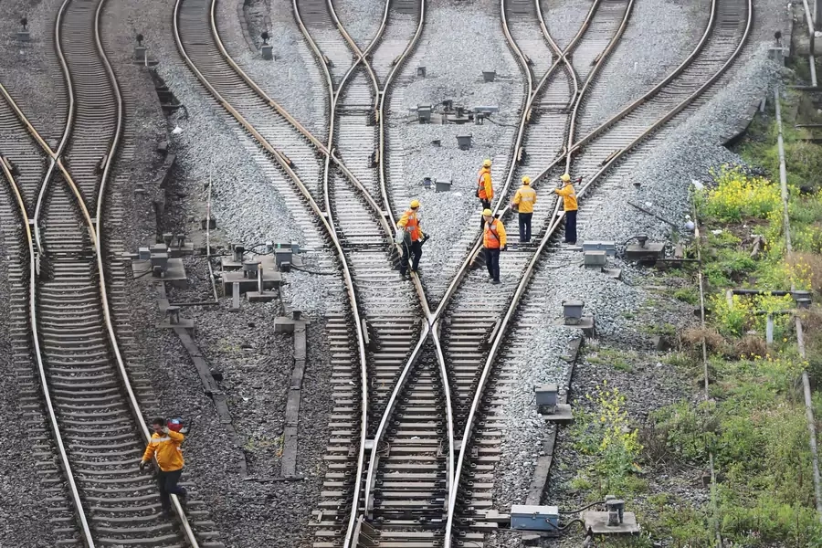 Workers inspect railway tracks, which serve as a part of the Belt and Road freight rail route linking Chongqing to Duisburg, at Dazhou railway station in Sichuan province, China. China Stringer Network/Reuters