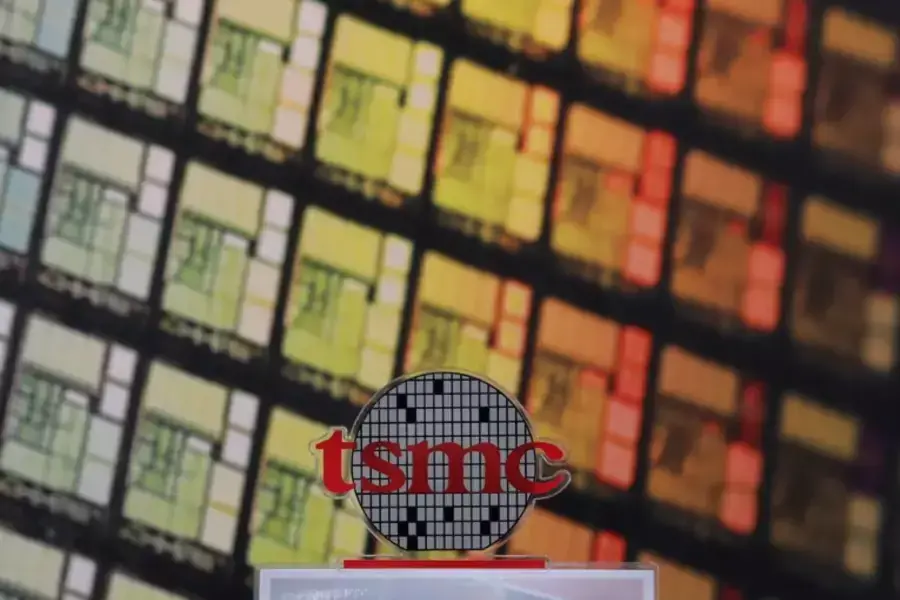 The logo of Taiwan Semiconductor Manufacturing Company (TSMC) can be seen alongside images of silicon chips in Hsinchu, Taiwan.