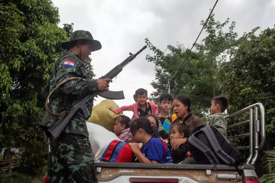 A member of the insurgent KNDF Karenni Nationalities Defence Force rescues civilians trapped amid airstrikes during a battle to take over Loikaw in Kayah State, Myanmar, on November 14, 2023. 