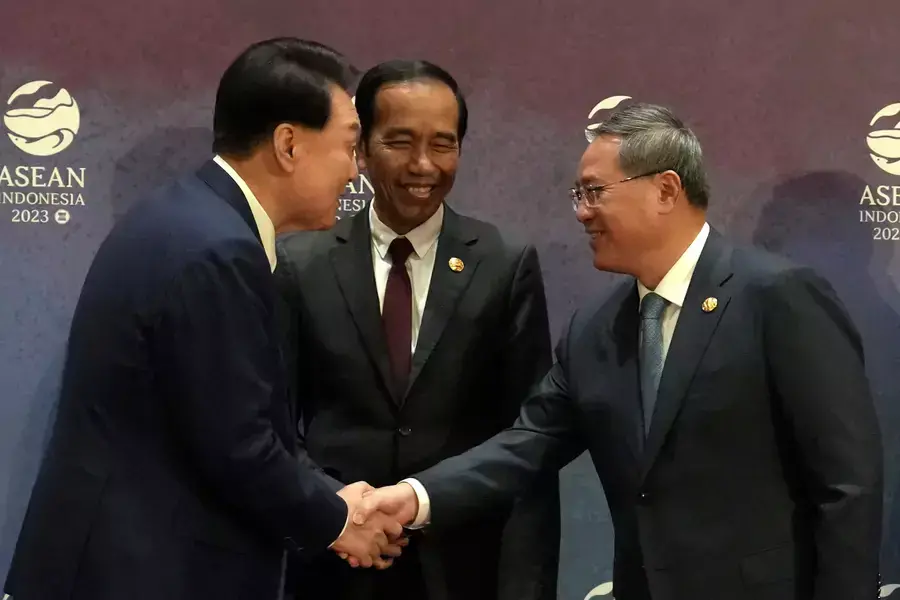 South Korean President Yoon Suk Yeol shakes hands with Chinese Premier Li Qiang as Indonesian President Joko Widodo looks on during the ASEAN Plus Three Summit in Jakarta, Indonesia, on September 6, 2023.