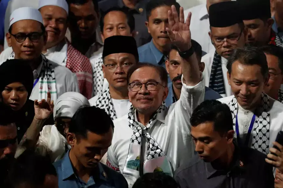 Malaysian Prime Minister Anwar Ibrahim waves during a solidarity gathering to show support for Palestinians, amid escalating conflict between Israel and Hamas, in Kuala Lumpur, Malaysia, on October 24, 2023.