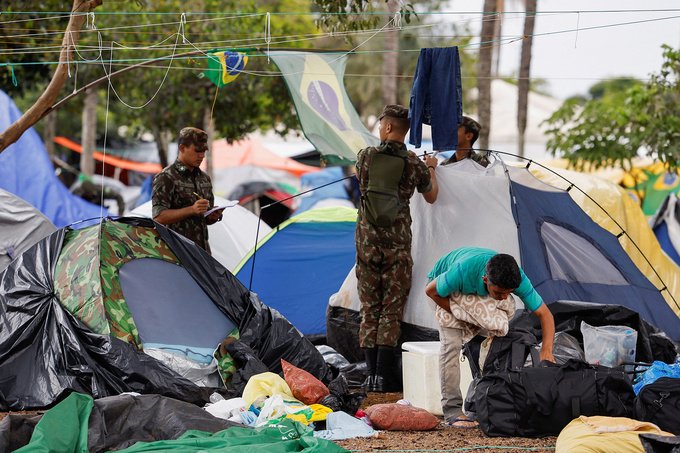 Members of the military take down tents at a camp left by supporters of Brazil's former President Jair Bolsonaro