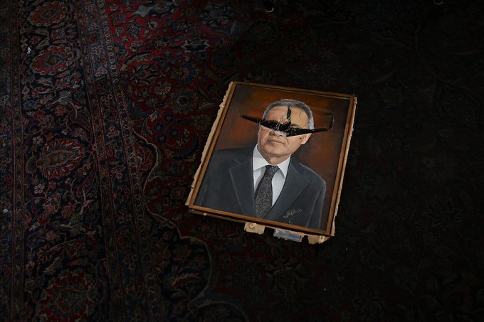 A vandalized painting depicting a political figure lies on a room at the National Congress in Brasilia