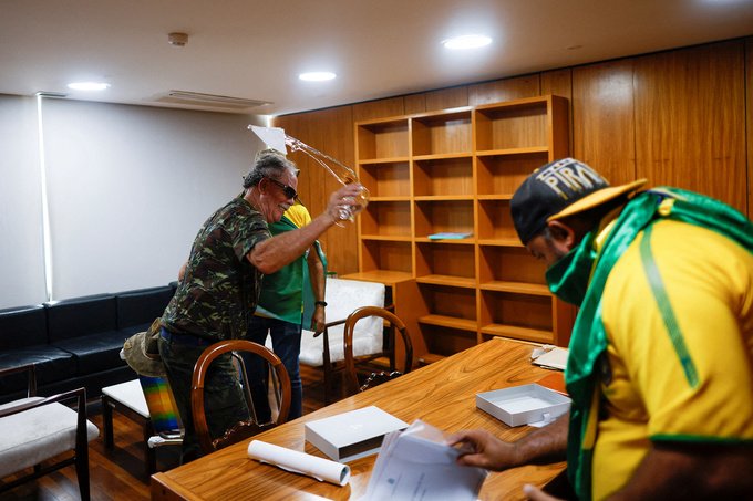 Supporters of Brazil's former President Jair Bolsonaro vandalize a room in Planalto Palace.
