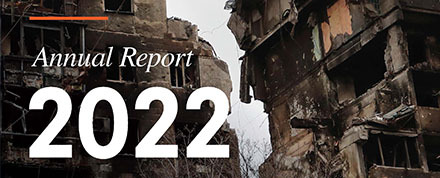 "Annual Report 2022" in white text over an image that shows the Ukrainian flag flying over destroyed buildings