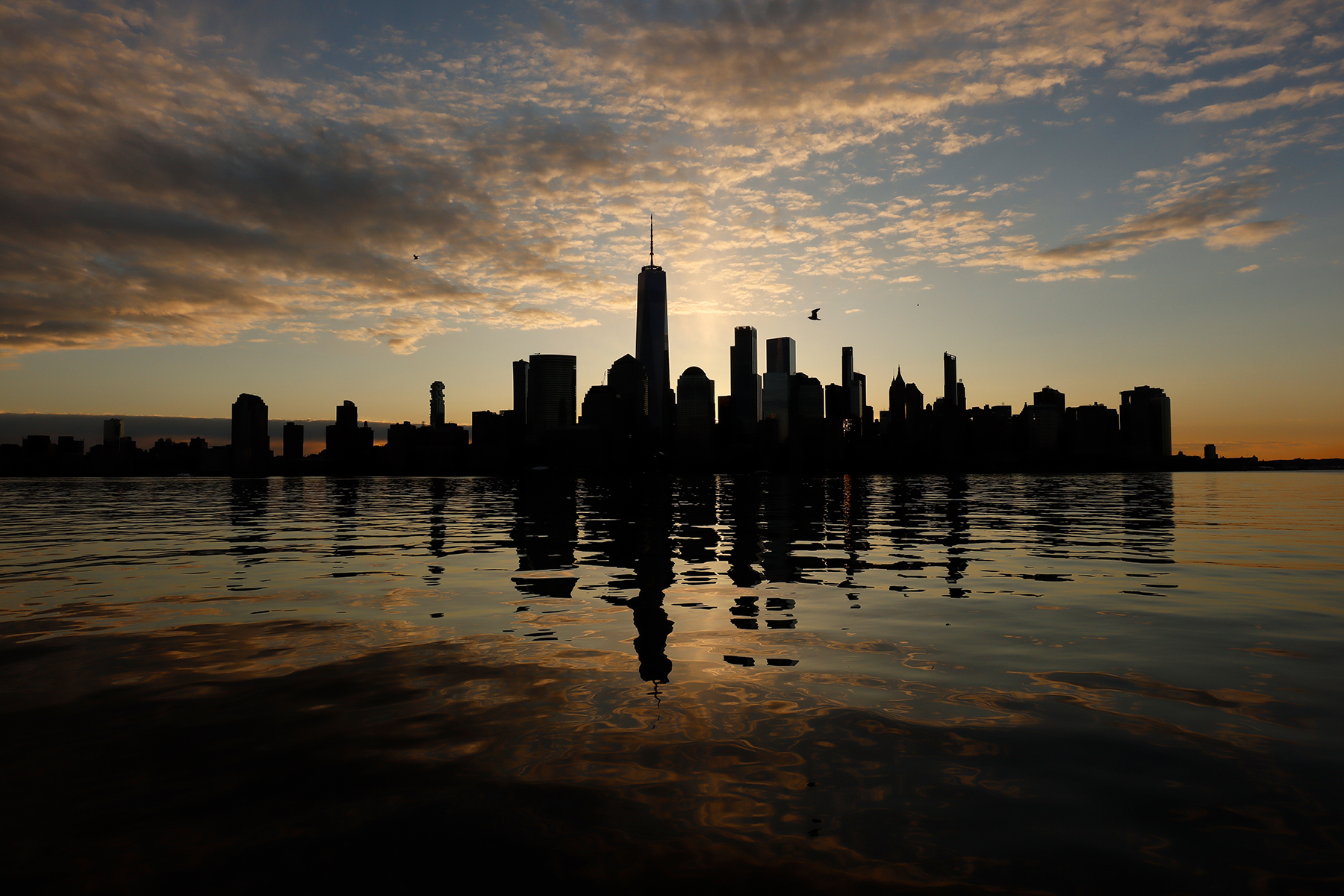 Picture of a silhouetted city skyline at sunset.
