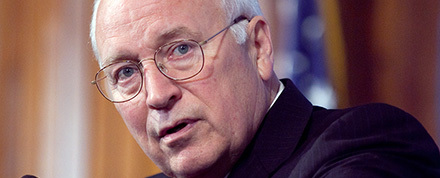 Dick Cheney stands behind a podium while giving remarks.