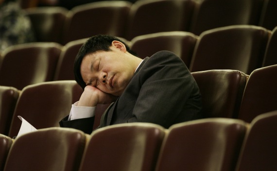 An unidentified official sleeps as Chinese Parliament chief Wu Bangguo delivers the work report of the National People’s Congress Standing Committee during the second plenary session at the Great Hall of the People in Beijing on March 9, 2009. 