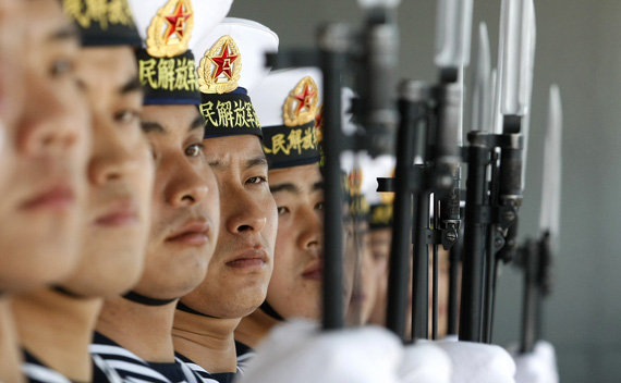 Chinese sailors stand guard onboard the Shi Jia Zhuang, a Luzhou class missile destroyer, at Valparaiso port, about 75 miles (121km) northwest of Santiago November 23, 2009. Two Chinese vessels docked at Valparaiso on Monday as the navies from both countries sought to exchange experiences as well as strengthen cooperation between each other. REUTERS/Eliseo Fernandez