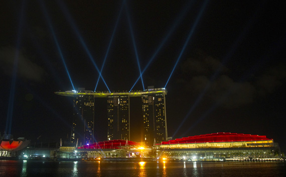 Searchlights beam off the site of the Marina Bay Sands integrated resort in Singapore