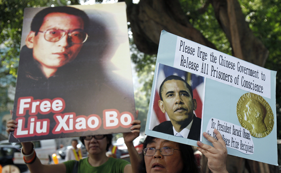 A demonstrator holds a picture of Chinese dissident Liu Xiaobo during a protest, urging Nobel peace prize recipient U.S. President Barack Obama to demand the Chinese government to release all dissidents, outside the U.S. Consulate General in Hong Kong October 23, 2009. REUTERS/Tyrone Siu