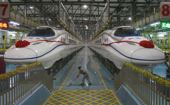 A labourer cleans the floor beside a China Railway High-speed (CRH) train preparing for the operation ceremony from Wuhan to Guangzhou in Wuhan, Hubei province, December 26, 2009. The Wuhan-Guangzhou high-speed railway, with the world’s fastest train journey at a 350-km-per-hour designed speed, started operation Saturday, Xinhua News Agency reported. REUTERS/China Daily