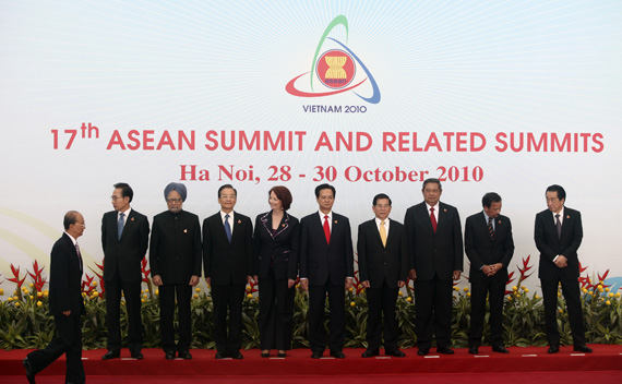 Myanmar’s Prime Minister Thein walks on as other ASEAN and East Asian leaders wait for their group photo session during the 17th ASEAN Summit in Hanoi