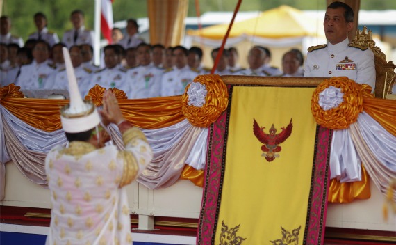 A Thai official dressed in a traditional costume greets Thailand’s Crown Prince Maha Vajiralongkorn (R) during an annual royal ploughing ceremony in cental Bangkok on May 13, 2011.