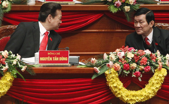 Vietnam’s Prime Minister Dung chats with senior Politburo member Sang while attending the closing ceremony of the 11th National Congress of the Party in Hanoi