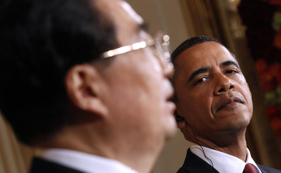 U.S. President Barack Obama looks on as Chinese President Hu Jintao speaks during a joint press conference in the East Room at the White House in Washington, January 19, 2011.