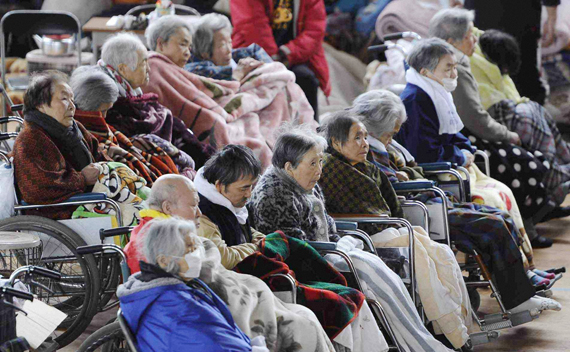 People on their wheelchairs rest at an evacuation centre in Kesennuma, Miyagi Prefecture in northern Japan, after an earthquake and tsunami struck the area, March 15, 2011.