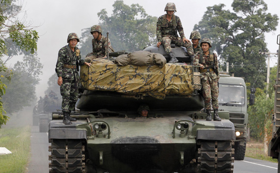 Thai army tanks travel on a road near the Thai-Cambodia border in Surin province April 28, 2011.