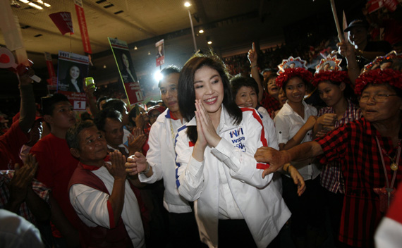 Yingluck Shinawatra is welcomed by her supporters during an election campaign in Chiang Mai province