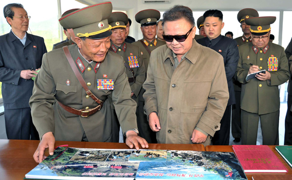 North Korean leader Kim Jong-il (front R), his son and vice-chairman of the Central Military Commission of the Workers’ Party of Korea, Kim Jong-un (2nd R, 2nd row) and other officials visit the construction site of the Huichon Power Station in this picture released by the North’s official KCNA news agency in Pyongyang June 1, 2011. 