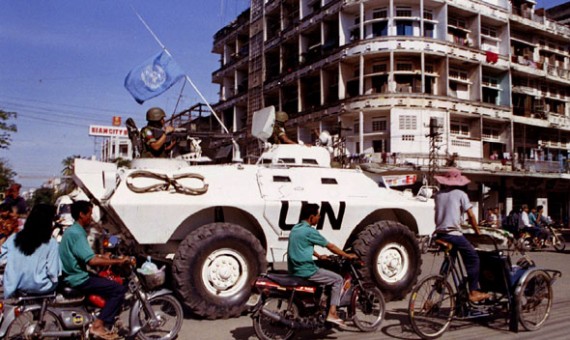 UN peacekeepers from Indonesia patrol the streets of Phnom Penh in an armoured personel carrier on August 27, amid the morning rush hour traffic