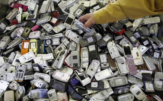 A worker holds one of scrap mobile phones, at a recycling facility of Re-Tem Corp, in Tokyo on October 15, 2010. Re-Tem Corp researches and develops the recycling of rare earth metals vital to the production of electronics. Japanese high-tech companies face higher input costs for rare earth metals as dominant supplier China curbs exports.