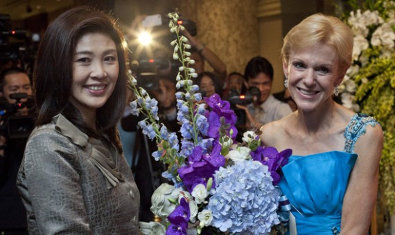 Thailand’s Prime Minister-elect Yingluck Shinawatra (L) poses for photographers as she gives United States ambassador to Thailand Kristie Kenney a bouquet of flowers ahead of U.S. Independence Day celebrations in Bangkok July 5, 2011.