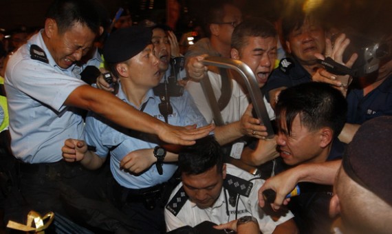 Pro-democracy protesters scuffle with police during a protest march to demand universal suffrage and against rising property prices in Hong Kong July 1, 2011.
