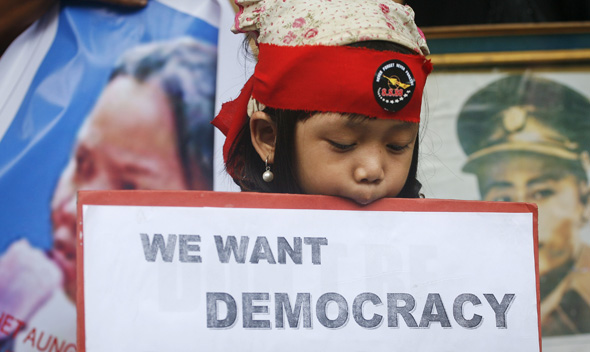 A girl of Myanmar heritage holds a placard during a pro-democracy rally in New Delhi August 8, 2011.