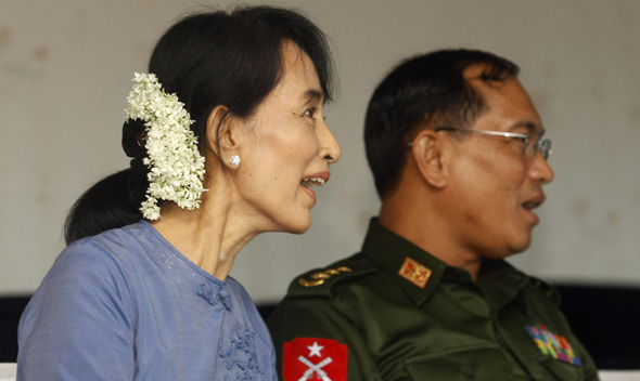 Myanmar Pro-Democracy leader Aung San Suu Kyi and Yangon Division government’s security and border affairs minister colonel Tin Win watch the Asean U-19 soccer match in Yangon.