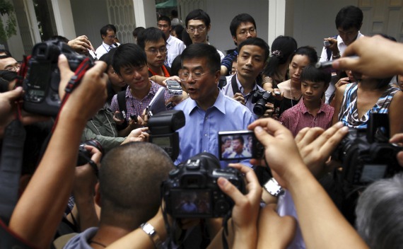 Ambassador Gary Locke is surrounded by local Chinese media outside his residence in Beijing on August 14, 2011. 