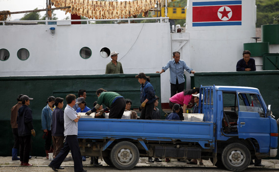 Local workers arrive with fresh fish at the port area of North Korean special economic zone of Rason city, located northeast of Pyongyang September 2, 2011.