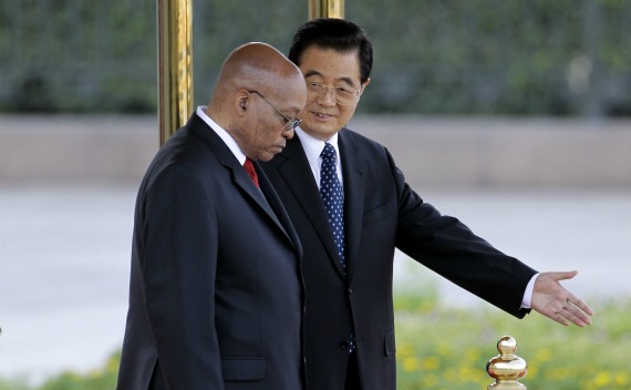 China’s President Hu Jintao shows the way to South Africa’s President Jacob Zuma during a welcome ceremony outside the Great Hall of the People in Beijing on August 24, 2010.