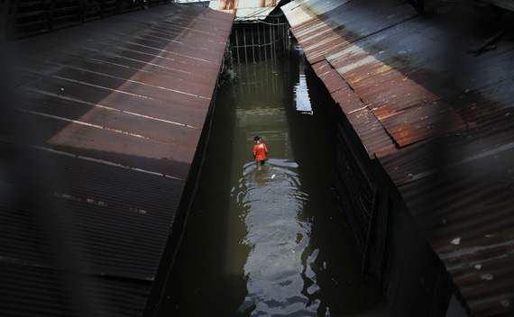 A boy walks through the water at a flooded market in Chinatown, central Bangkok.