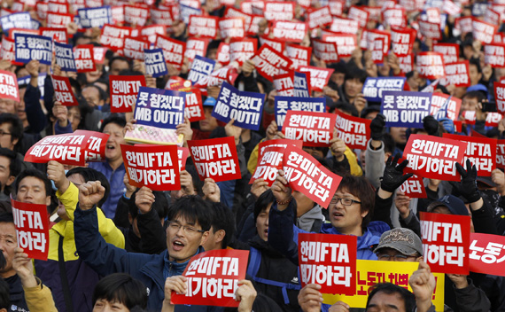 Union workers from Korean Confederation of Trade Unions shout slogans during a demonstration in Seoul