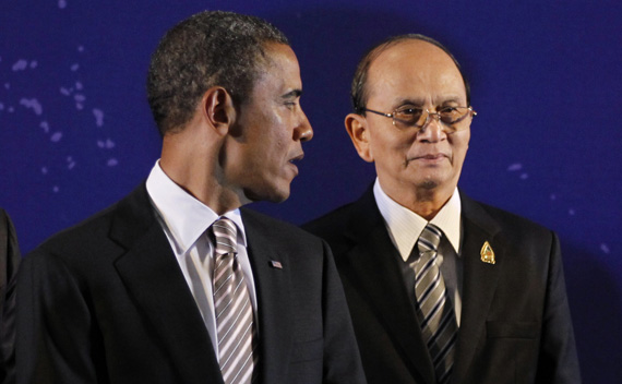 U.S. President Obama looks back at Myanmar’s President Thein Sein as they participate in a group photo of leaders at the East Asia Summit in Nusa Dua.