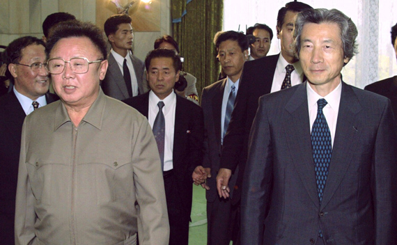 Japanese Prime Minister Junichiro Koizumi (R) is accompanied by North Korean leader Kim Jong-il to a conference room for their landmark summit in Pyongyang in this September 17, 2002 file photo