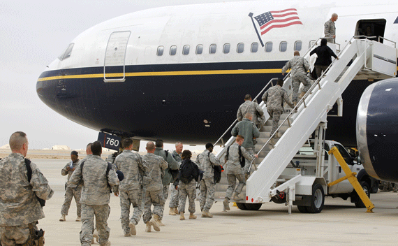 Members of the U.S. Air Force board a plane before flying to the U.S., at al-Asad air base in Iraq’s western province of Anbar November 1, 2011. U.S. President Barack Obama announced on Oct. 21 that American troops would fully withdraw from Iraq by year-end, as scheduled under a 2008 security pact between the two countries. Picture taken November 1, 2011. REUTERS/Mohammed Ameen 