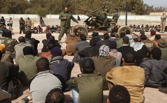 Rebel soldiers teach civilian volunteers at a school in Benghazi on March 2, 2011.