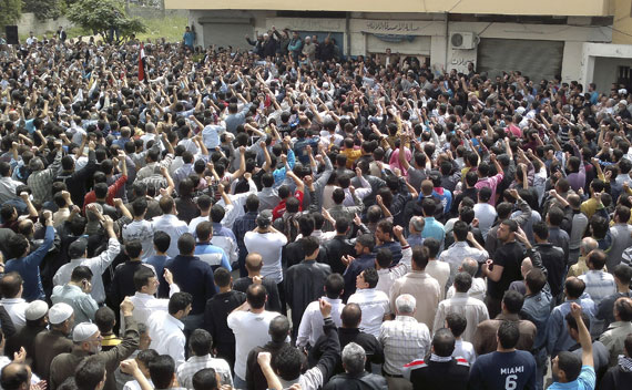 Protesters shout slogans during a demonstration after Friday prayers in the Syrian port city of Banias April 29, 2011.