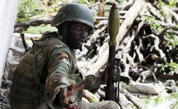 A peacekeeper from the African Union Mission to Somalia (AMISOM) armed with a rocket launcher takes up position near the main Bakara Market as they battle against Islamist insurgents in the capital Mogadishu May 22, 2011