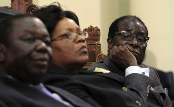 Zimbabwean President Robert Mugabe (R) listens as Finance Minister Tendai Biti delivers his budget speech in parliament in Harare November 24, 2011 (Philimon Bulawayo/Courtesy Reuters)