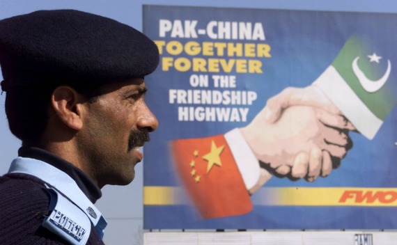 A Pakistani policeman keeps watch near a Pakistan-China friendship billboard in Islamabad February 3, 2002. (Claro Cortes IV / Courtesy Reuters)